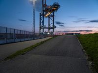 a view of the highway and some fenced off area of an airport during sunset