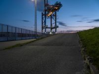 a view of the highway and some fenced off area of an airport during sunset