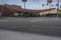 a street intersection with red stripes and palm trees in the background at sunset time,