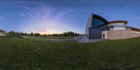 this is an 360 - view of the beautiful landscape outside of an architectural building at sunset