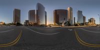 a wide angle view of a city at sunset through an fish eye lens lens ball