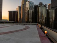 cityscape and skyscrapers at sunset viewed from the roof of a building with lots of windows