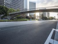 the sun is just going down over a deserted highway as it passes under a bridge