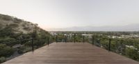 a deck overlooking the mountains is seen at sunset in this house by artist beni