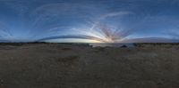 an image of the sun setting over the ocean from within it with some big clouds