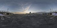 a 360 - vr of the sun setting over an empty parking lot with some white writing