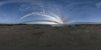 a reflection of the sky in a fish - eye lens of a large sun set on the horizon