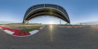 a man is driving his motorcycle at the racetrack as sun goes down near him on a sunny day