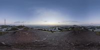 the reflection of an eyeglass lens on a hillside at sunset shows a view of a mountainous city