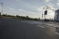 an image of the sun going down in the city as seen from a car traveling on a highway