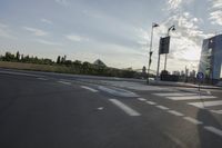 an image of the sun going down in the city as seen from a car traveling on a highway