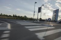 an image of the sun going down in the city as seen from a car traveling on a highway