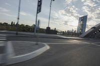 an image of the sun going down in the city as seen from a car traveling on a highway