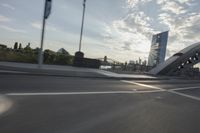 an image of the sun going down in the city as seen from a car traveling on a highway