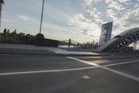 an image of the sun going down in the city as seen from a car traveling on a highway