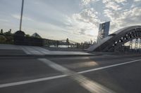 an image of the sun going down in the city as seen from a car traveling on a highway