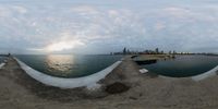 a city is shown through the panoramic lens of this picture at sunset as viewed from a concrete wall