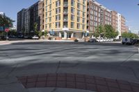 this is an outside view of a city intersection at sunset time with buildings and other cars