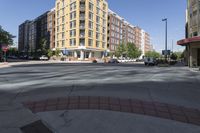 this is an outside view of a city intersection at sunset time with buildings and other cars