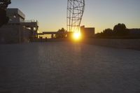 the view from the top of a parking ramp as the sun sets in the distance