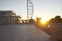 the view from the top of a parking ramp as the sun sets in the distance