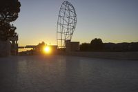 the view from the top of a parking ramp as the sun sets in the distance