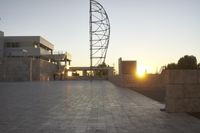 the view from the top of a parking ramp as the sun sets in the distance