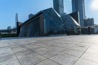 this is an image of modern buildings and a public square with some plants on the ground