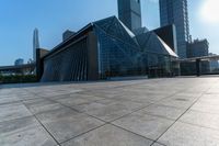 this is an image of modern buildings and a public square with some plants on the ground