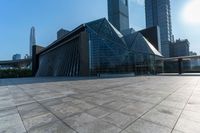 this is an image of modern buildings and a public square with some plants on the ground