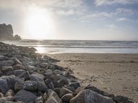 this is an image of a person riding a surfboard on a beach near the ocean