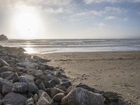 this is an image of a person riding a surfboard on a beach near the ocean