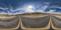 a surreal view of an intersection in a desert area with two roads lined by tarps