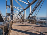 a pier with lots of water and a bridge for pedestrians to cross across it to get out