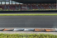 this is an image of a field that is full of grass and bricks near a stand