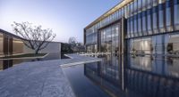 the modern house is reflecting in the water pool of its glassy pool of water