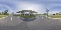 a panorama lens of a skate park with some umbrellas on the top of one