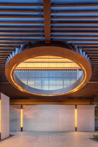 the ceiling and wall have multiple lighting in it and is suspended from the roof with wood slats