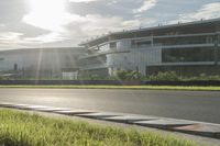 the sun shining over an airport with multiple runways and a street with traffic lights at the top of the road