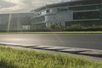 the sun shining over an airport with multiple runways and a street with traffic lights at the top of the road