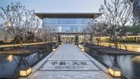 the walkway leads to a hotel lobby where visitors can walk from the pool and across the front yard