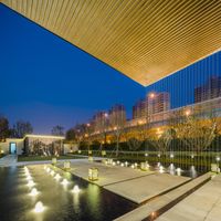 lighted fountains in a modern setting at dusk in a city center with tall buildings and modern lighting