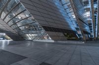 the inside of a building has some metal glass panels on it's side and a stone pathway