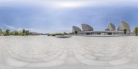 the park is empty and has many stone benches in it with geometric circular designs on its surface