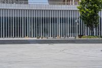 a person on a skateboard rides by an office building in downtown atlanta, usa