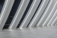 a row of columns are decorated with light strips of varying sizes and color, including black and white