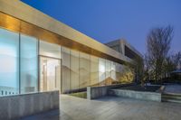 a walkway with stairs leading into a glass enclosed area area outside of the building on the right