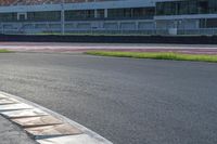 a man on skateboard riding through a track with multiple flags on it in the background