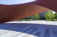 a large red structure in a park with many trees in it and stars scattered all over the space