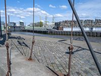 the swing is chained to a pole near the river bank and the city of hamburg